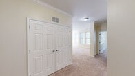 Located at 311 Lowell St in Andover, Massachusetts, this single-floor residential unit offers a thoughtfully designed layout with a warm, neutral color palette throughout. The open living area is generously sized, featuring plush wall-to-wall carpeting and crown molding accents, and flows seamlessly into the kitchen via a peninsula counter — ideal for both everyday living and entertaining. The kitchen is well-appointed with rich cherry wood cabinetry, granite-style countertops, hardwood-style flooring, and black appliances including a range with overhead microwave. Bedrooms are carpeted and bright, with large windows that invite natural light and offer pleasant outdoor views. Each bedroom features six-panel closet doors providing ample storage. The unit includes two full bathrooms, each finished with warm tile flooring, wood-toned vanity cabinetry, and a tub/shower combination. One bathroom features classic white subway tile surround, while the other offers a clean, minimalist aesthetic. Throughout the unit, consistent trim work, recessed vents, and neutral warm-beige tones contribute to a cohesive and comfortable atmosphere. This well-maintained space is a practical and inviting option in the desirable Andover community.