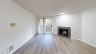 Located at 3702 Auburn Way S in Auburn, WA, this 2-bedroom, 3-bathroom residence offers a well-designed, single-floor layout with a clean, neutral aesthetic throughout. The open living area is anchored by a tile-surround fireplace and features wood-look flooring, a textured ceiling, and a ceiling fan. Sliding glass doors lead to a private balcony, bringing in natural light and outdoor views of surrounding greenery. The kitchen is efficiently laid out with white cabinetry, wood-trimmed open shelving, laminate countertops, a stainless steel sink, dishwasher, and electric range. The living and kitchen areas flow openly, supported by a pass-through counter. The bedrooms are well-proportioned, with the primary offering generous closet space and wood-look flooring. A secondary bedroom features a large picture window with vertical blinds, a baseboard heater, and abundant natural light with views of the surrounding trees. Each bathroom is finished with clean, light-toned surfaces, wood-look flooring, and full tub-shower combinations. A dedicated in-unit laundry area houses a full-size Maytag washer and dryer with overhead shelving. A hallway with additional closet storage connects the rooms efficiently, completing this functional and comfortable residence.