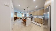Located at 3930 Paradise Rd in Las Vegas, NV, this well-appointed two-bedroom, two-bathroom residence offers a thoughtfully designed single-level layout with modern finishes throughout. The open-concept living and kitchen area serves as the heart of the home, featuring light wood-tone cabinetry, a full suite of stainless steel appliances, a subway tile backsplash, and a central island with seating for four, illuminated by stylish globe pendant lights. Light-toned flooring runs throughout, enhancing the bright, airy feel of the space. The living room is generously proportioned, offering large windows dressed with blinds and linen drapes that invite abundant natural light. Ceiling fans provide comfort in both the living area and bedrooms. The primary bedroom is a comfortable retreat, featuring a window with natural light, a ceiling fan, and direct access to its own bathroom, which includes a wood-vanity with an integrated sink, an illuminated mirror, and an adjacent walk-in closet with built-in shelving. The second bedroom and bathroom are equally well-finished. Two dedicated closets provide ample storage throughout the residence, completing this polished and functional Las Vegas home.