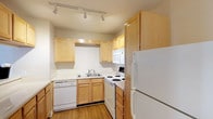 The Fremont is a thoughtfully designed two-bedroom, two-bathroom residence arranged on a single floor. The layout connects the living areas cohesively, with a pass-through kitchen opening toward the main living space, creating an open, communicative feel throughout.

The kitchen is well-appointed with light maple cabinetry offering generous upper and lower storage, white appliances including a dishwasher, electric range, built-in microwave, and refrigerator, complemented by track lighting overhead and warm hardwood-style flooring underfoot.

The living area features neutral carpet, a ceiling fan with light fixture, and French doors that open to an outdoor patio, allowing natural light to flow into the space. Both bedrooms are comfortably sized, finished with plush carpet, ceiling fans, and windows that bring in natural light.

Each bathroom is cleanly appointed, featuring a tub/shower combination, a wood-vanity with countertop sink, a lighted mirror, and tile flooring. The overall ambiance of the residence is bright and neutral, providing a versatile, move-in-ready environment suitable for a variety of living arrangements.