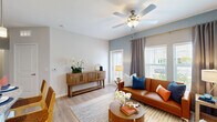 Located at 8263 NW Selvitz Rd in Port Saint Lucie, FL, this one-bedroom, one-bathroom residence offers a well-designed, single-story layout with a cohesive open-concept floor plan. Light wood-look flooring runs throughout, complementing the bright, neutral color palette that defines the space.

The living room is warm and inviting, featuring a ceiling fan with light fixture, a soft blue accent wall, and large windows that allow ample natural light to filter in. The space flows seamlessly into a dedicated dining area, which is tucked into a cozy nook accented by stylish wall art.

The kitchen is well-appointed with gray shaker-style cabinetry extending to the ceiling for generous storage, granite countertops, a white subway tile backsplash, stainless steel appliances, and a peninsula with a sink — ideal for both cooking and casual dining.

The bedroom is a comfortable retreat, offering two large windows with garden views, light wood floors, and ample room to furnish. A hallway connects the bedroom to the full bathroom, which features a granite-topped vanity with an undermount sink, gray cabinetry with gold hardware, a tub-shower combination, and wood-look tile flooring. This residence combines functional design with modern finishes in a convenient Port Saint Lucie location.