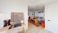 Located at 4166 Lindell Blvd in St. Louis's vibrant Central West End neighborhood, this thoughtfully designed two-bedroom, one-bathroom unit offers a clean, contemporary aesthetic across a well-utilized single floor. Light hardwood flooring flows throughout, tying together each room with a warm, cohesive feel.

The galley-style kitchen is a standout feature, outfitted with flat-front light wood cabinetry, a marble-look tile backsplash, white quartz countertops, and gold-toned fixtures including a sleek faucet and hardware. Stainless steel appliances and under-cabinet lighting complete the modern, functional design. Natural light enters through a window at the end of the kitchen corridor.

The living area is bright and open, with recessed lighting and white walls that create an airy atmosphere. The primary bedroom benefits from multiple windows on two walls, allowing for generous natural light, and includes a ceiling fan. The second bedroom is equally well-lit with its own ceiling fan and convenient access to an in-unit washer and dryer.

The bathroom features large-format hexagonal floor tile, marble-look shower surround, a wood-toned vanity, and gold fixtures, offering a refined and cohesive design. The entry is seamlessly integrated into the kitchen area, maintaining an efficient and uncluttered layout throughout.
