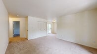 Located at 7875 W Mansfield Pkwy in Lakewood, Colorado, this single-floor, 2-bedroom, 1-bathroom residence offers a practical and comfortable layout designed for everyday living. The kitchen is outfitted with warm honey-toned oak cabinetry spanning both upper and lower sections, white appliances including a refrigerator and electric range, and rich hardwood-style flooring that adds a classic touch to the space. A built-in range hood and ample counter space make this kitchen as functional as it is inviting. The living area features neutral carpet flooring, bright white walls, and a window that allows natural light to fill the room, creating an open and airy atmosphere. Both bedrooms are carpeted and finished with neutral tones, offering a calm and restful environment. Each bedroom includes a louvered bi-fold closet, providing organized storage. The primary bedroom is generously sized with direct access to an outdoor area. The shared bathroom features hardwood-style flooring, a single vanity with storage, a lighted mirror, and a full tub-shower combination. Throughout the residence, clean lines and a consistent neutral palette create a cohesive, move-in-ready atmosphere well-suited to a variety of lifestyles.