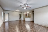 Located at 17802 Mound Rd in Houston, TX, this two-story, 2-bedroom, 2-bathroom home offers a well-designed layout across two levels. The main living area is an open-concept combined living and dining room, featuring rich hardwood-style flooring, crown molding, a ceiling fan with light, and multiple windows that invite generous natural light and neighborhood views. The kitchen is equipped with dark cabinetry, granite countertops, a tile backsplash, stainless steel appliances, and a breakfast bar that connects seamlessly to the living area. A dedicated laundry room with washer hookups is conveniently accessible from the kitchen. The ground level also includes an attached garage with an automatic opener, providing secure parking and additional storage. Carpeted staircases with wooden handrails lead to the upper floor, where both bedrooms are found. Each bedroom features plush carpet, a ceiling fan, natural light from windows with outdoor views, and ample closet space. The bathrooms include dark wood vanities with light countertops and a glass-enclosed walk-in shower. A pantry, hallway, and multiple closets throughout the home contribute to its practical and functional design.