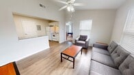 This 660 sq ft, single-floor apartment in Lafayette, LA features 2 bedrooms, 2 bathrooms, and an efficient open-concept layout. The living room boasts high ceilings, a ceiling fan, large windows with natural light, and wood-look flooring. The adjacent kitchen includes white cabinetry, granite-style countertops, a full refrigerator, electric range, dishwasher, and microwave. Both bedrooms are carpeted and include walk-in closets, with the primary bedroom measuring 130 sq ft. Each bathroom features a tub/shower combo. Two additional closets provide ample storage throughout the unit.