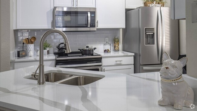 Modern Kitchen with Quartz Countertops, Fridge, and Tile Backsplash - Enders Place at Baldwin Park