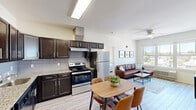 This well-appointed 2-bedroom, 2-bathroom residence at 512 Hamilton St in Somerset, NJ offers a thoughtfully designed single-floor layout that maximizes comfort and functionality. The open-concept kitchen and living area serves as the heart of the home, where the kitchen stands out with rich dark cabinetry, granite countertops, a tile backsplash, stainless steel appliances including a range and refrigerator, and a wall-mounted range hood. Light wood-look tile flooring runs through the kitchen and living areas, adding warmth and continuity. The living room is filled with natural light from large windows that frame neighborhood views, and features a ceiling fan for added comfort. Both bedrooms are carpeted and generously sized, with the primary bedroom offering its own dedicated closet space. Each bedroom benefits from natural light through well-placed windows. The two bathrooms are finished with wood-look tile flooring; one includes a full tub-shower combo with stylishly tiled surround and a rich wood vanity, while the second is a clean, functional full bath. Neutral tones and clean lines throughout create a bright, modern ambiance that is both welcoming and easy to personalize.