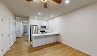Located at 1241 Florence St in Nokomis, FL, this 1-bedroom, 1-bathroom unit offers a thoughtfully designed single-level layout with a clean, modern aesthetic throughout. Light wood-tone flooring flows seamlessly across all rooms, complemented by crisp white walls and bright recessed lighting that create a fresh, airy atmosphere.

The open-concept living, dining, and kitchen area serves as the heart of the unit. The kitchen features white shaker-style cabinetry, a peninsula with a breakfast bar overhang, stainless steel appliances including a refrigerator, microwave, and electric range, and a ceiling fan overhead. The connected living and dining spaces offer flexible use and easy flow.

The bedroom is a comfortable, well-proportioned room equipped with a ceiling fan, a window with outdoor views, and a large sliding-door closet. Additional storage is provided by multiple closets throughout the unit. A dedicated office space adds versatile functionality, ideal for working from home.

The bathroom includes a white vanity with ample drawer storage, a tub/shower combination with tiled surround, and the same warm wood-tone flooring. An in-unit laundry area and a private patio round out the practical amenities. The unit's clean design and efficient layout make it a well-appointed residence in the Nokomis area.