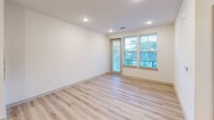 Located at 451 W Blount Ave in Knoxville, TN, this well-appointed 1-bedroom, 1-bathroom unit offers a thoughtfully designed single-floor layout. The open-concept kitchen and living area serves as the heart of the home, featuring crisp white shaker cabinets, dark countertops, a subway tile backsplash, and a center island with pendant lighting and a built-in sink. Stainless steel appliances—including a refrigerator, range, and microwave—complete the kitchen. Light hardwood-style flooring flows throughout the main living areas, complemented by recessed lighting and large windows that invite abundant natural light. The living area provides access to a private balcony through a glass-paneled door. The bedroom offers a comfortable retreat with plush carpet, a ceiling fan, and multiple windows with outdoor views. Two closets—fitted with wire shelving systems for organized storage—serve the bedroom. The bathroom features a dark-countertop vanity with white cabinetry, a large mirror with stylish light fixtures, and a tiled soaking tub. Additional conveniences include a dedicated laundry space and a utility room, rounding out this functional and modern Knoxville residence.