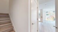 Located at 8460 Ash St in Vancouver, BC, this two-storey, 2-bedroom, 2-bathroom home offers a well-planned layout spread across two floors of nearly equal size. The interior is finished in a clean, contemporary style throughout, with light hardwood flooring, crisp white walls, and modern fixtures that create a bright and cohesive aesthetic.

The main floor hosts an open-concept combined living and dining area filled with natural light from large floor-to-ceiling windows. The kitchen is well-appointed with light wood cabinetry, white upper cabinets, a classic subway tile backsplash, stainless steel appliances including a bottom-freezer refrigerator and range, and a sleek white countertop with an undermount sink. A hallway and convenient in-suite laundry room round out the lower level.

Upstairs, both bedrooms feature light hardwood floors and clean white walls. The primary bedroom includes a sliding-door closet, while additional closet space is distributed throughout the home. Both bathrooms are finished with light wood vanities, white countertops, full soaker tubs with tiled surrounds, and illuminated medicine cabinet mirrors. A private balcony provides outdoor access, complementing the functional and modern character of this well-designed Vancouver residence.