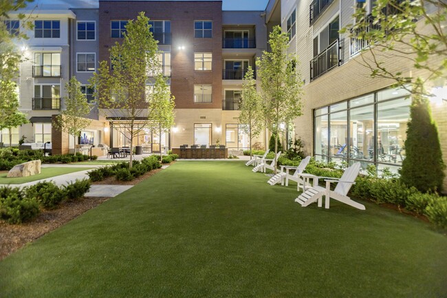 Resident courtyard with ample seating and lush landscaping - Hanover Weymouth