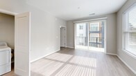 Located at 4301 Dominion Forest Cir in Glen Allen, VA, this 2-bedroom, 2-bathroom residence offers a well-designed, single-floor layout with a bright and contemporary feel throughout. Light wood-style flooring flows consistently across the living spaces, complementing the neutral gray-toned walls and crisp white trim.

The open-concept living and dining area is generously proportioned, filled with natural light from large windows and a sliding glass door that opens to a private balcony. The kitchen features light wood cabinetry, stainless steel appliances including a refrigerator with ice maker, range, and microwave, along with a clean white countertop and a window above the sink.

Both bedrooms are well-lit with large windows offering views of the surrounding greenery. The primary bedroom includes a ceiling fan and access to a dedicated walk-in closet with built-in wire shelving. The second bedroom features a stylish barn-style sliding door for closet access.

The primary bathroom offers a long vanity with modern cabinetry, a large mirror, and a glass-enclosed shower. The second bathroom includes a full soaking tub with shower combo and a matching vanity. A hallway connects the living spaces to the bedrooms and bathrooms, creating an efficient and functional floor plan.