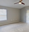 This 1,020 square foot apartment in Sarasota, FL offers a contemporary living space with two bedrooms and two bathrooms. The open-concept design seamlessly integrates the kitchen and living area, creating a spacious feel. The kitchen features wooden cabinetry, black appliances, and granite countertops, providing both functionality and style.

The primary bedroom, measuring 220 square feet, offers ample space and includes a ceiling fan for comfort. Both bedrooms are carpeted and equipped with ceiling fans, ensuring a cozy atmosphere. The bathrooms are well-appointed, with one featuring a shower/tub combination and the other a walk-in shower.

Throughout the apartment, neutral-toned walls and carpeting create a blank canvas for personalization. Large windows and sliding glass doors allow natural light to flood the space, while blinds offer privacy when needed. The apartment also includes closet space with wire shelving for organized storage.

The overall design prioritizes functionality and comfort, making it an ideal living space for those seeking a modern, low-maintenance home in Sarasota.