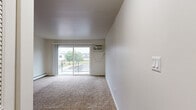 Located in Palos Hills, IL, this 2-bedroom, 1-bathroom home offers a well-organized single-floor layout designed for comfortable everyday living. The living room is a bright, open space featuring plush carpeting, a ceiling fan, a baseboard heating unit, and a sliding glass door that opens to a private balcony, allowing natural light and outdoor views to fill the room. Adjacent to the living area, the galley-style kitchen is well-appointed with white cabinetry, white quartz countertops, light wood-tone flooring, and stainless steel appliances including a gas range, built-in microwave, dishwasher, and full-size refrigerator. Both bedrooms are carpeted and feature windows that bring in natural light, with views of the surrounding greenery. The primary bedroom includes a walk-in closet outfitted with multiple shelving rods for ample storage. A second bedroom offers a louvered bi-fold closet and convenient access to the hallway. The shared full bathroom is clean and functional, featuring a tiled tub-shower combination, a single-sink vanity, and wood-look flooring. Baseboard heating is present throughout, and the overall interior palette of neutral whites and grays creates a cohesive, move-in-ready atmosphere.