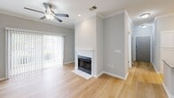 Located at 520 Windview Way in Knoxville, TN, this well-appointed 2-bedroom, 2-bathroom single-floor home offers a thoughtfully designed layout with quality finishes throughout. The open-concept living, dining, and kitchen area forms the heart of the home, anchored by light hardwood flooring and crown molding. The living room features a classic white-mantled fireplace, a ceiling fan, and sliding glass doors that open to a private patio, filling the space with natural light. The kitchen is outfitted with white shaker-style cabinetry, granite countertops, stainless steel appliances including a refrigerator, range, microwave, and dishwasher, and a double-basin sink. Both bedrooms are carpeted and feature ceiling fans, crown molding, and windows with natural light. The primary bedroom includes its own en-suite bathroom with a dual-sink granite vanity and a tub-shower combination. The second bathroom mirrors the same refined aesthetic with a granite vanity. Additional highlights include three closets providing ample storage, a dedicated laundry room with a top-load washer, and a clean, neutral color palette throughout that creates a bright and cohesive atmosphere.