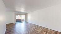 Located at 10139 Woodley Avenue in North Hills, CA, this 1-bedroom, 2-bathroom residence offers a clean, modern aesthetic with a thoughtfully designed single-floor layout. Wood-style flooring flows consistently throughout, complementing the bright white walls and creating a warm, cohesive atmosphere across all rooms.

The spacious living room is anchored by sliding glass doors that open onto a private balcony, filling the space with natural light and providing outdoor access. An adjoining dining area connects seamlessly to the galley-style kitchen, which features white shaker cabinetry, granite countertops, a built-in wall oven, and a stainless steel sink — offering ample storage and prep space.

The generously sized primary bedroom includes a ceiling fan, a large window with outdoor views, and access to multiple closets for plentiful storage. Two full bathrooms serve the home — one featuring a soaking tub and vanity, and the other a walk-in shower with glass enclosure — both finished with clean, contemporary fixtures.

Three closets and multiple hallways enhance functionality throughout the unit. The overall ambiance is light, airy, and well-maintained, making this North Hills residence a practical and comfortable space.