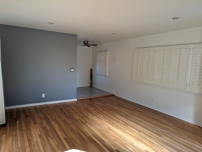 living room plantation shutters - 3406 McManus Ave
