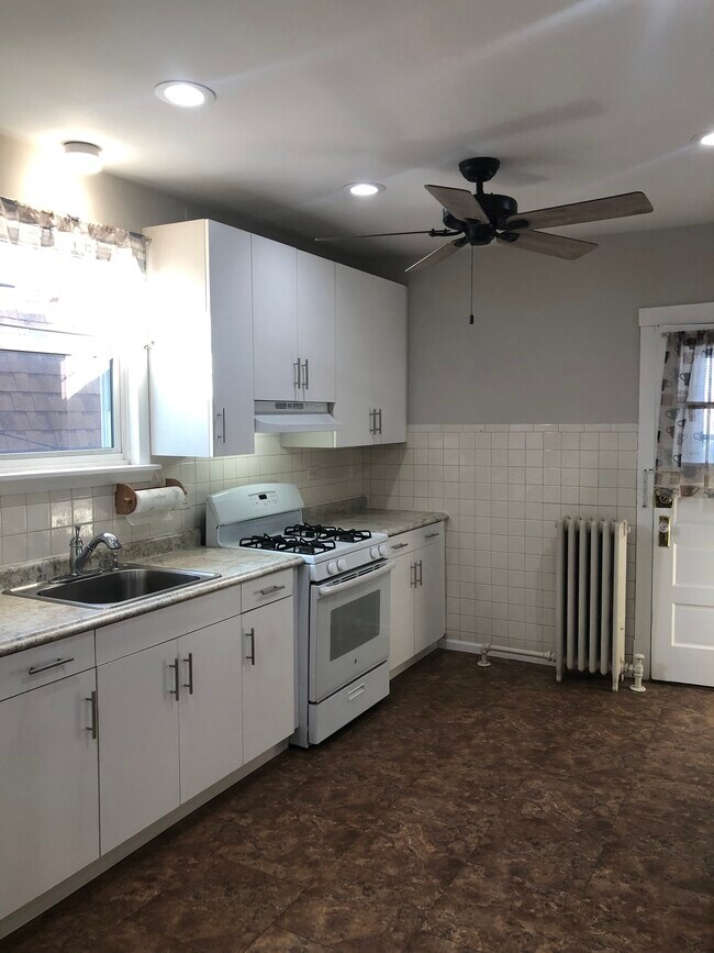 New cabinets and flooring with recessed lighting. - 4526 N Menard Ave
