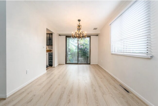 Dining with chandelier and sliding doors - 329 W Main St