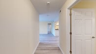 This well-appointed 2-bedroom, 2-bathroom residence at 39 Buckland St in Manchester, CT offers a comfortable and functional single-floor layout. A welcoming hallway with light wood-style flooring leads into the open living room, which is bathed in natural light from large sliding glass doors that open to an outdoor view of surrounding trees — creating a bright, airy atmosphere throughout.

The kitchen is efficiently designed with ample white cabinetry, stainless steel appliances including a gas range, dishwasher, and refrigerator, complemented by a double sink and light flooring that ties the space together seamlessly.

Both bedrooms feature plush carpeting and warm neutral tones. The generously sized primary bedroom offers a built-in closet with shelving, while a second bedroom provides a large window with pleasant wooded views. Each bathroom is finished with tile flooring, a white vanity, and clean fixtures; one bathroom includes a full tub-shower combination with tiled surround.

A dedicated in-unit laundry area houses a full-size top-loading washer and dryer, adding everyday convenience. Throughout the residence, consistent warm beige walls, white trim, and updated finishes create a clean, move-in-ready environment suited for comfortable living in Manchester, CT.