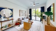 Located at 19 NE First Ct in Dania Beach, Florida, Unit 518 at Seaside presents a thoughtfully designed single-level residence with a clean, contemporary aesthetic throughout. The open-concept layout connects the kitchen, dining, and living areas in a seamless flow, making the space feel expansive and functional.

The kitchen is outfitted with warm wood-grain cabinetry extending floor to ceiling, white quartz countertops, a stainless steel refrigerator, range, microwave, and dishwasher. Large-format porcelain tile flooring runs throughout the main living areas, enhancing the sense of continuity and light.

The living area features white walls, recessed lighting, and a ceiling fan, with floor-to-ceiling sliding glass doors opening to a balcony with lush tropical views. A compact dining nook sits adjacent, offering a practical yet stylish space for daily use.

The bedroom is bright and serene, with a sliding glass door that brings in natural light, neutral carpet, and a full-width closet for ample storage.

The bathroom features marble-style tile surrounding the tub and shower combination, a wood-toned vanity, and white quartz surfaces. A small nook near the kitchen provides additional flexible space. The overall ambiance is modern, airy, and ideally suited to Florida's coastal lifestyle.