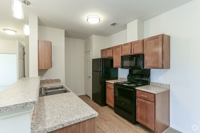 Kitchen with Breakfast Bar - Fairway Landings at Plum Creek