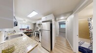 Located on Melrose Avenue in Seattle's vibrant Capitol Hill neighborhood, this one-bedroom, one-bathroom unit offers a thoughtfully designed single-floor layout with modern finishes throughout. The galley-style kitchen is a standout feature, showcasing marble-style countertops, crisp white cabinetry, stainless steel appliances including an electric range and refrigerator, and light wood-style flooring that extends into the adjoining living area. Flush ceiling lighting keeps the kitchen bright and functional. The living room offers a comfortable, open feel with neutral tones and easy flow from the kitchen. The bedroom is a well-proportioned retreat featuring soft carpet flooring, a large window with urban views, neutral walls, and a sliding closet with wire shelving for organized storage. The bathroom is cleanly appointed with a marble-style vanity countertop, white cabinetry, a mirror with overhead lighting, and a tub/shower combo over wood-style flooring. A dedicated laundry room houses a full-size LG front-loading washer/dryer unit, adding everyday convenience. The overall aesthetic is clean, modern, and move-in ready, with consistent light tones creating a cohesive and welcoming atmosphere throughout.