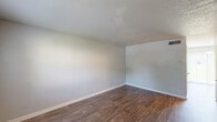 Located at 301 W Vandalia Rd in Greensboro, NC, this two-story residence offers 3 bedrooms and 2 bathrooms across two well-organized floors. The main level features durable hardwood-style flooring throughout the living areas and kitchen, complemented by neutral light gray walls and textured ceilings that lend a clean, consistent aesthetic. The kitchen is efficiently designed with white cabinetry, light countertops, and a full suite of black appliances including a refrigerator, electric range, dishwasher, and a stainless sink — providing practical functionality in a compact layout. Both full bathrooms include a tub-shower combination with white tile surround and standard fixtures. The upper level houses the bedrooms, each finished with plush carpet flooring and soft gray walls. The generously sized primary bedroom offers a comfortable retreat. Additional bedrooms feature windows that invite natural light, with one bedroom showcasing a built-in closet with a sliding door. A dedicated closet with a hanging rod provides extra storage. A connecting hallway and staircase link both floors seamlessly, and a second kitchen area adds versatility to the layout. The overall design is clean, functional, and move-in ready.