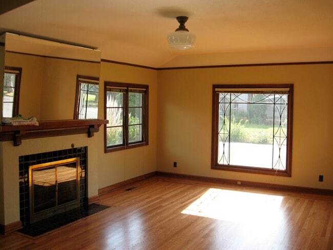 Living room with large leaded window facing west. - 2910 NE Mason