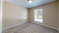 Located on Fair Oaks Blvd in Carmichael, California, this single-story, one-bedroom, one-bathroom unit offers a practical and well-organized layout. The galley-style kitchen features white cabinetry with ample upper and lower storage, light-toned countertops, a stainless steel sink, and wood-look flooring, along with a white range and dishwasher for everyday convenience. The bedroom is carpeted and bathed in natural light from a window with blinds, complemented by a textured ceiling and a flush-mount light fixture. A spacious built-in closet with louvered bi-fold doors provides generous storage. The bathroom is neatly finished with wood-look flooring, a vanity with a wide countertop and under-sink cabinetry, a large mirror, globe lighting, and a tub/shower combo with tile surround. Neutral, warm beige tones are carried throughout the unit, giving the space a clean and cohesive feel. The efficient floor plan makes excellent use of every square foot, making this unit a straightforward and functional living space in a convenient Carmichael location.