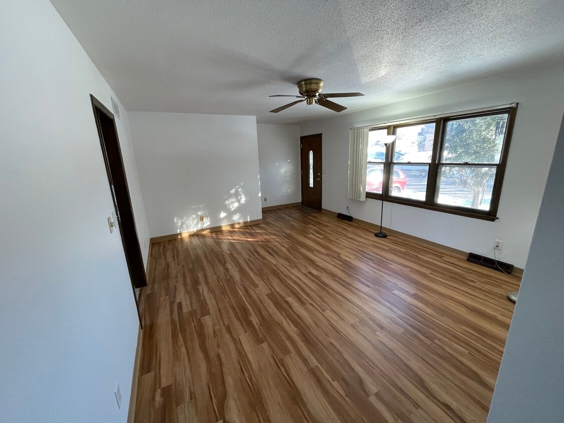 Living room, with large window, looking at front door. - 715 Westgate St (Iowa City, IA)