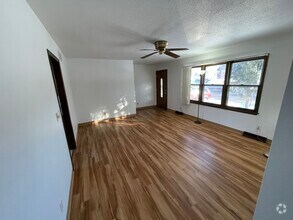 Living room, with large window, looking at front door. - 715 Westgate St