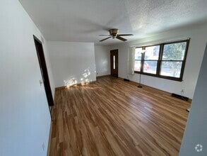 Living room, with large window, looking at front door. - 715 Westgate St