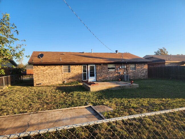 Fenced backyard with storm shelter. - 1404 San Ann Dr