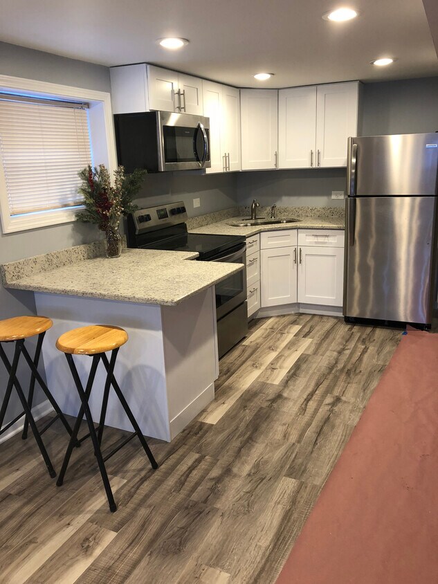 Kitchen with granite countertops and stainless steel appliances - 3532 N Oriole Ave