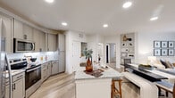 Located in Fort Worth, TX, this thoughtfully designed 2-bedroom, 2-bathroom residence offers a comfortable and modern living experience across a single floor. The open-concept kitchen and living area serves as the heart of the home, featuring light wood-style flooring, recessed lighting, and a seamless flow between spaces. The kitchen is equipped with taupe shaker-style cabinetry, stainless steel appliances including a French door refrigerator, electric range, and microwave, all complemented by granite countertops and a central island with bar seating — ideal for casual dining or entertaining. A built-in shelving unit and mudroom-style entry nook add functional storage near the front door. The living room is bright and inviting, with clean white walls and large windows that bring in natural light. Both bedrooms are generously sized, each featuring plush carpet, ceiling fans, and windows with outdoor views. The spacious primary bedroom includes a large walk-in closet with built-in shelving and hanging rods. The bathrooms are finished with granite vanities, tile surrounds, and matte black fixtures. This residence combines modern aesthetics with practical design throughout.