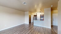 Located at 9331 Westridge Blvd in Frisco, TX, this well-appointed one-bedroom, one-bathroom unit offers a thoughtfully designed single-floor layout. The open-concept living and kitchen area serves as the heart of the home, featuring durable wood-look flooring, neutral warm-toned walls, and a ceiling fan that enhances air circulation. Natural light filters in through multiple windows, brightening the space throughout the day.

The kitchen is a functional highlight, showcasing rich dark cabinetry, granite countertops, stainless steel appliances including a full-size refrigerator, and a curved peninsula with pendant and track lighting overhead — ideal for casual dining or meal prep.

The generously sized primary bedroom is carpeted for comfort, complete with a ceiling fan, two windows that invite natural light, and access to closet storage. The bathroom continues the consistent design aesthetic with dark cabinetry, a granite-topped vanity, wood-look flooring, and a shower-tub combination.

Additional practical features include a dedicated laundry area, hallway storage, and two closets. The unit's cohesive design, neutral palette, and quality finishes throughout make it a comfortable and functional living space in the heart of Frisco.