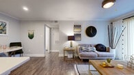 Located at 3816 S Lamar Blvd in Austin's vibrant 78704 corridor, this one-bedroom, one-bathroom unit offers a thoughtfully designed single-floor layout that maximizes every square foot. Rich wood-style flooring flows throughout, tying the open-concept living and kitchen areas together seamlessly. The combined kitchen and living room serves as the heart of the unit, featuring a central island with white quartz countertops, white shaker cabinetry, a full suite of stainless steel appliances — including a refrigerator, dishwasher, range, and over-the-range microwave — and a gray subway tile backsplash. The adjacent living area is bright and inviting, with a sliding glass door that welcomes natural light and opens to an outdoor balcony view. A hallway leads to the generously sized primary bedroom, which comfortably accommodates large furniture and is outfitted with a ceiling fan and a dedicated walk-in closet. The full bathroom features a white vanity with an undermount sink and a shower-tub combination. A dedicated laundry area and utility room add everyday practicality. Crown molding and neutral gray walls give the space a clean, modern aesthetic throughout.