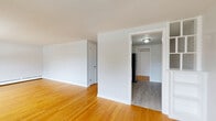 Located at 187 S Allen St in Albany, NY, this 2-bedroom, 1-bathroom unit offers a practical and well-maintained single-floor layout. Warm-toned hardwood flooring runs consistently throughout the space, lending a cohesive and inviting feel to every room. The open living area is bright and simply finished with crisp white walls, baseboard heating, and clean lines that maximize the sense of openness.

Both bedrooms are comfortably sized, each featuring the same hardwood floors, neutral wall tones, and baseboard heating. The primary bedroom includes a sliding closet door for convenient storage. Windows in the bedrooms allow natural light to filter in and offer views of the surrounding Albany neighborhood's brick building streetscape and tree-lined surroundings.

The bathroom is finished in a clean, classic style with a full tub-shower combination featuring white tile surround, a traditional black-and-white mosaic tile floor, and white fixtures throughout. The hallways connect each room efficiently, contributing to the unit's organized and functional flow. Overall, this space presents a tidy, no-frills aesthetic with durable finishes well-suited for everyday living in a residential Albany neighborhood.