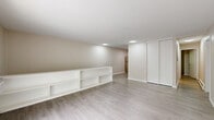 Located at 11 Farnsworth Dr in Slingerlands, NY, this single-floor, 2-bedroom, 1-bathroom home offers a well-organized and functional layout. The living room serves as the centerpiece of the home, featuring light hardwood-style flooring, neutral beige walls, and a sliding glass door that opens to a balcony, flooding the space with natural light and outdoor views of lush greenery. Built-in shelving along one wall adds practical storage and display options. The kitchen is efficiently designed in an L-shaped configuration, showcasing white cabinetry, light countertops, and a full suite of stainless steel appliances including a refrigerator, dishwasher, and electric range. Light wood-style flooring carries through this area, complementing the clean, bright aesthetic. Both bedrooms are carpeted and feature neutral tones, offering a comfortable and quiet retreat. The spacious primary bedroom includes a sliding closet, while the second bedroom also benefits from closet storage. One bedroom enjoys a large window with views of the surrounding trees, enhancing the sense of connection to the outdoors. Baseboard heating is present throughout. The full bathroom is clean and simply appointed with a tub and shower combination. The overall ambiance is understated, functional, and move-in ready.