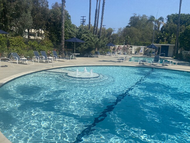 Circular pool with fountain - 241 S Barrington Ave