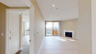 Located on Franklin Avenue in the heart of Hollywood, this 2-bedroom, 2-bathroom residence offers a well-designed layout with a blend of modern updates and comfortable living. The open-concept living room is a bright, welcoming space featuring light wood-style flooring, recessed lighting, warm neutral walls, and a classic white fireplace. Sliding glass doors lead to a private balcony that overlooks a tree-lined streetscape with panoramic views of the surrounding Los Angeles skyline. The galley-style kitchen is a standout, outfitted with bold blue shaker cabinetry, white quartz countertops, a mosaic tile backsplash, stainless steel appliances, and marble-look porcelain tile flooring — all framed by a window with natural tree views. The primary bedroom offers generous proportions, plush carpeting, floor-to-ceiling mirrored closet doors, and a large window that fills the room with natural light. The second bedroom mirrors the same comfortable finishes with carpet and bright window exposure. Both bathrooms are finished with marble-style tile floors and blue vanities that coordinate with the kitchen's design palette. Two dedicated closets provide ample storage throughout. This residence combines stylish, updated interiors with an enviable Hollywood location.