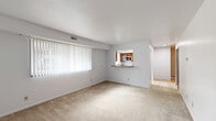 Located at 527 Greenwich Dr in Howell, Michigan, this one-bedroom, one-bathroom unit offers a well-organized single-floor layout that makes efficient use of its space. The open living room is a standout feature, boasting plush carpeting, crisp white walls, and a large window dressed with vertical blinds that floods the room with natural light and provides outdoor views. The entry door with its dark wood finish adds a warm, classic touch to the living area.

The galley-style kitchen is thoughtfully designed with warm-toned wooden cabinetry, granite-style countertops, and light wood-look flooring. It is equipped with white appliances including a refrigerator, electric range, microwave, and dishwasher. A window above the counter brings in additional natural light, making the kitchen feel bright and functional.

The spacious bedroom features soft carpeting, neutral walls, and a large window with vertical blinds, creating a calm and comfortable retreat. A dedicated closet provides convenient storage.

The bathroom is clean and modern, featuring light wood-look flooring, a sleek sliding glass shower enclosure with built-in shelving, and a vanity with ample counter space. Throughout the unit, the consistent use of neutral tones and natural light creates a cohesive, inviting atmosphere.