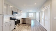 Located at 705 South 6th Street in Nashville's vibrant East Side neighborhood, this well-appointed one-bedroom, one-bathroom unit offers a thoughtfully designed layout across a single floor. Light wood-style flooring runs throughout the space, creating a cohesive and contemporary feel.

The open-concept kitchen and living area serves as the heart of the unit. The kitchen is outfitted with gray shaker-style cabinetry extending to the ceiling, granite countertops, white subway tile backsplash, and a full suite of stainless steel appliances including a French door refrigerator, electric range, over-the-range microwave, and dishwasher. A central island with a sink and pendant lighting above adds both functionality and style. The adjacent living area is bright and open, with neutral walls and access to a private balcony with outdoor views.

The bedroom features dual windows that invite generous natural light, a ceiling fan, and direct access to a dedicated closet with built-in shelving. The bathroom includes gray vanity cabinetry with a granite countertop, a framed mirror with open shelving, large-format tile flooring, and a tiled tub-shower combination. Clean finishes and a neutral palette give the entire unit a fresh, move-in-ready appeal.