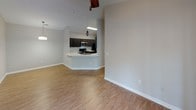 This single-floor home offers a thoughtfully designed layout that balances comfort and functionality. The living room serves as the heart of the space, highlighted by soaring vaulted ceilings and a classic white-mantled fireplace, creating a warm and inviting atmosphere. Light wood-look flooring flows throughout the main living areas, adding a clean, contemporary feel.

The kitchen is well-equipped with dark espresso cabinetry, a white quartz countertop, a subway tile backsplash, and a full suite of stainless steel appliances. A peninsula with an undermount double sink provides additional prep space and opens seamlessly to the living and dining areas, making it ideal for everyday living and entertaining.

The bedrooms are carpeted for comfort and feature neutral tones, ceiling fans, and generous natural light. The primary bedroom includes direct access to an en-suite bathroom, while a standout arched window in one of the bedrooms adds architectural character and frames views of surrounding greenery.

Both bathrooms are finished with quartz countertops, dark wood vanities, and tiled tub-shower combinations. The clean, neutral palette throughout the home provides a versatile backdrop, while the consistent design language across all rooms creates a cohesive and move-in-ready environment.