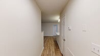 Located at 3343 Glade Creek Blvd NE in Roanoke, Virginia, this well-appointed single-floor home offers three bedrooms, two bathrooms, and a thoughtfully designed layout. The kitchen is a standout feature, showcasing white shaker cabinetry, granite-style countertops, stainless steel appliances including a refrigerator with ice maker, range, microwave, and dishwasher, along with a peninsula with an undermount sink — all complemented by light wood-look flooring and track lighting. The open living room is bright and inviting, featuring French doors that lead to an outdoor area and the same warm wood-look flooring. The bedrooms are carpeted for comfort, each offering generous natural light through large windows with views of surrounding greenery. The spacious primary bedroom includes a double-door closet and a ceiling fan. The bathrooms are clean and functional, with one featuring a soaking tub and shower combination with white tile surround. A dedicated laundry room houses a full-size washer and dryer with overhead shelving for added storage. The home also includes a hallway closet and central HVAC. Neutral tones and clean finishes throughout create a bright, move-in-ready atmosphere.