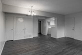 Located at 23167 Ironwood Ave in Moreno Valley, California, this single-floor residence offers a clean, move-in-ready interior with a cohesive design throughout. Light-toned wood-look flooring runs consistently across all rooms, providing a warm and unified aesthetic.

The spacious living and dining area is highlighted by a textured popcorn ceiling and an elegant chandelier that anchors the dining space. The open layout allows for flexible furniture arrangements, and large windows and a sliding glass door flood the area with natural light while offering views of the surrounding greenery.

The kitchen is well-appointed with white cabinetry, light stone-patterned countertops, and a full suite of white appliances including a gas range, built-in microwave, and dishwasher. A skylight overhead adds brightness to the functional U-shaped layout.

The bedrooms are generously sized, each featuring wide windows that frame pleasant outdoor views of mature trees and the surrounding neighborhood, filling the rooms with natural light. Neutral walls throughout keep the palette fresh and versatile.

The bathroom is thoughtfully finished with a full tub-shower combination, a vanity with mirrored medicine cabinet, and matching wood-look flooring, maintaining the home's consistent style. The overall ambiance is bright, clean, and welcoming.