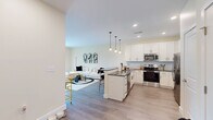 Located at 747 N DuPont Hwy in Dover, Delaware, this well-appointed one-bedroom, one-bathroom residence offers a thoughtfully designed single-floor layout. The open-concept living and dining area is bright and inviting, featuring warm neutral tones, light wood-style flooring, and large sliding glass doors that flood the space with natural light and lead to a private balcony with outdoor views.

The kitchen is a standout feature, showcasing white shaker-style cabinetry, dark countertops, a full suite of stainless steel appliances, and a peninsula with bar seating illuminated by pendant lighting — ideal for casual dining and entertaining.

The bedroom offers a comfortable, cozy retreat with a large window dressed with blinds and curtain panels, a closet, and continued use of warm flooring throughout. The bathroom is generously proportioned, featuring white cabinetry, a dark countertop with an undermount sink, a wide vanity mirror, and a shower-tub combination.

Throughout the residence, consistent warm beige walls and light flooring create a cohesive, clean aesthetic. The balcony provides an additional outdoor living space with views of the surrounding area, completing this well-rounded and functional home.