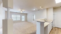 Located at Villa Capri Circle in Odessa, FL, this well-appointed 2-bedroom, 4-bathroom residence offers a thoughtfully designed single-floor layout. The open-concept living and kitchen area serves as the heart of the home, where wood-look flooring flows beneath a kitchen featuring white cabinetry, stainless steel appliances including a refrigerator, range, and microwave, and a curved breakfast bar with a built-in sink. The living area is bathed in natural light from large windows and a glass door that leads to a private balcony, with a ceiling fan overhead adding to the comfortable atmosphere. Both bedrooms are generously sized, finished with plush carpet, ceiling fans, and large windows fitted with blinds that filter natural light. The primary bedroom offers a comfortable retreat with ample proportions. The four bathrooms are clean and functional, each featuring tub/shower combinations, wood-look flooring, and vanities with neutral countertops. Three closets provide abundant storage throughout the residence. A dedicated laundry room with in-unit washer and dryer adds everyday convenience. The overall aesthetic is bright and neutral, with warm beige tones and clean white trim creating a welcoming, move-in-ready environment.