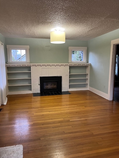 living room with built in bookshelves around a natural gas fireplace - 810 E Magnolia Ave